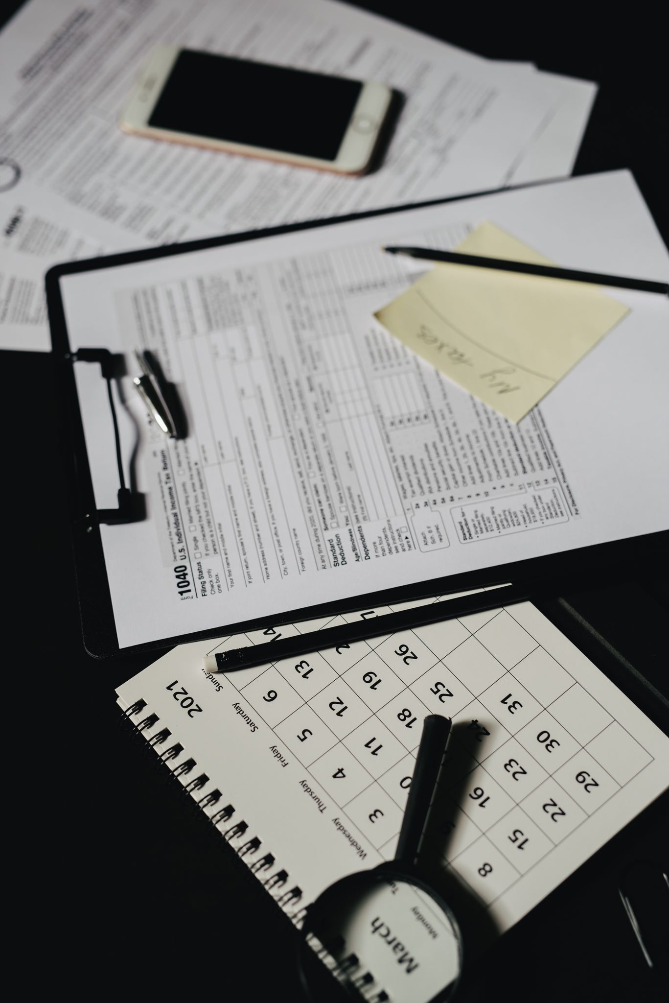Top view of an organized workspace with documents, a calendar, and office supplies.